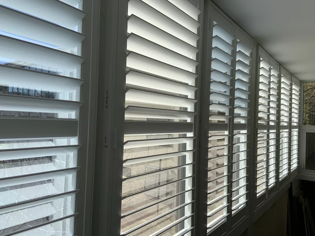 Wide PVC shutters from ShutterLux for very wide window in a condo