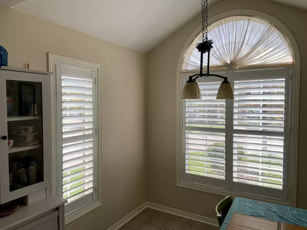 Dining room with California shutters installed by ShutterLux