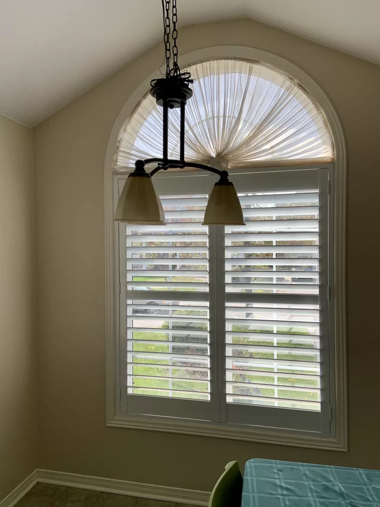 Dining room with California shutters installed by ShutterLux