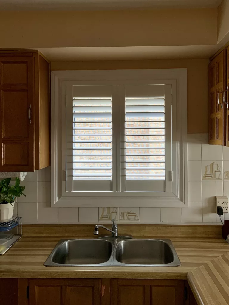 Kitchen Window with PVC california shutters by ShutterLux Scarborough